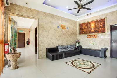 a living room with a couch and a ceiling fan at My Town Hotel in Ipoh
