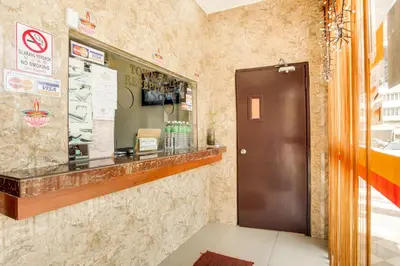 a restaurant with a counter and a door at My Town Hotel in Ipoh