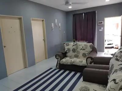 a living room with a couch and a chair at Anis Homestay Gua Musang in Gua Musang