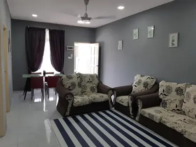 a living room with a couch and chairs and a table at Anis Homestay Gua Musang in Gua Musang