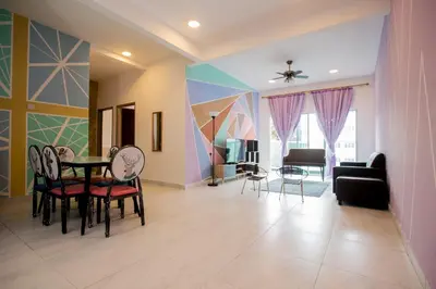 a living room with a table and chairs at ICOLOR HOME & STAY CH 8 in Tanah Rata