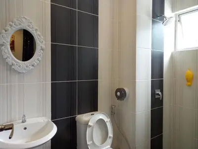 a bathroom with a sink and a toilet and a mirror at ICOLOR HOME & STAY CH 8 in Tanah Rata