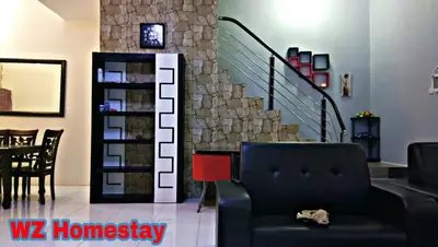 a living room with a staircase and a chair at Double Storey @ Tapah in Tapah