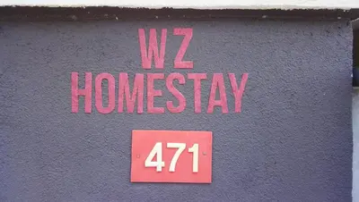 a sign on the side of a building with the words homesay at Double Storey @ Tapah in Tapah