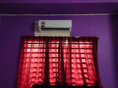 a room with a heater and a window with red curtains at Double Storey @ Tapah in Tapah