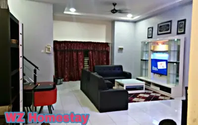 a living room with a couch and a tv at Double Storey @ Tapah in Tapah
