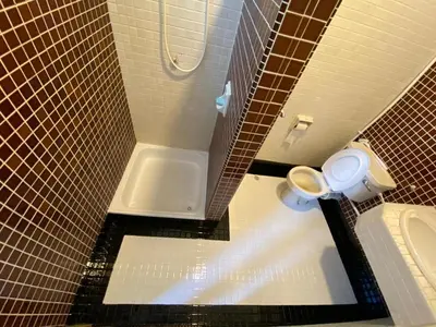 a bathroom with a toilet and a bath tub at Arcadia Penang by Plush in George Town