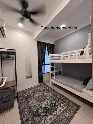 a bedroom with two bunk beds and a ceiling fan at Casahome by Irdina Meru- 8pax -10pax in Ipoh