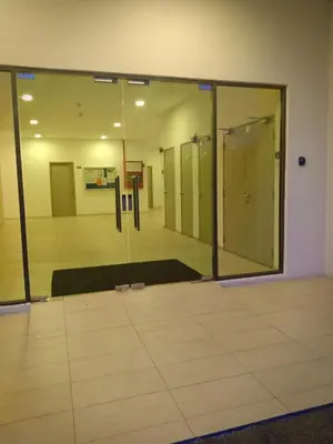 an empty room with glass doors and ailed floor at Casahome by Irdina Meru- 8pax -10pax in Ipoh