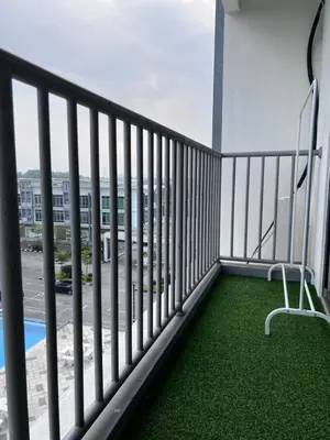 a balcony with two chairs and a pool at Casahome by Irdina Meru- 8pax -10pax in Ipoh