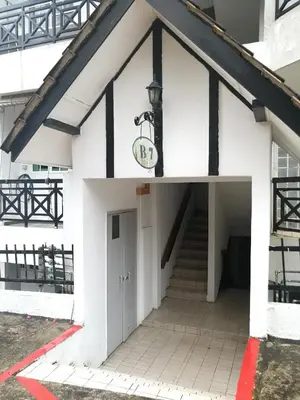 a white building with a door and stairs at The Haven Retreat B7-2-1 ( Silverpark) in Bukit Fraser