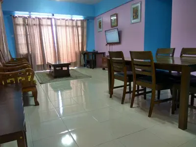a living room with a dining room table and chairs at Tenang & Tranquil Homestay - B605 Cameron Highlands in Brinchang