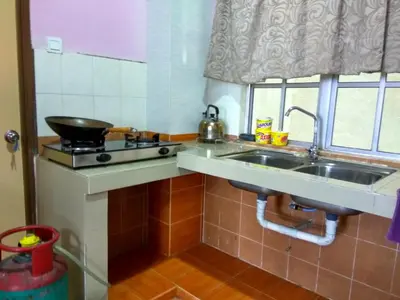 a small kitchen with a sink and a stove at Tenang & Tranquil Homestay - B605 Cameron Highlands in Brinchang