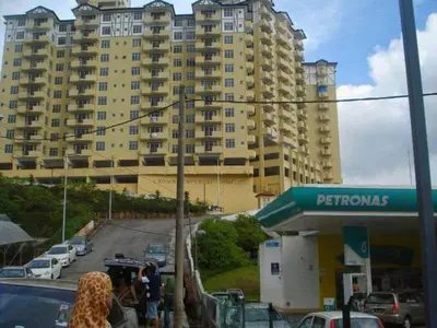 a gas station in front of a large building at Tenang & Tranquil Homestay - B605 Cameron Highlands in Brinchang