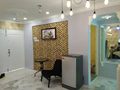 a room with a table and a chair and a wall at Fastbook Majestic Home 10pax in Ayer Itam