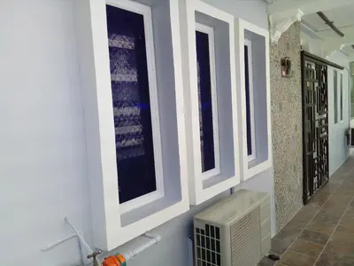 a bathroom with three windows on the wall at Fastbook Majestic Home 10pax in Ayer Itam