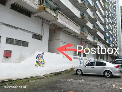 a car parked in front of a building with a sign at Fastbook Majestic Home 10pax in Ayer Itam