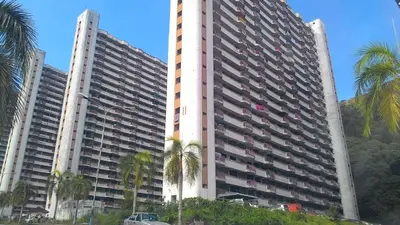 two tall buildings with palm trees in front of them at Fastbook Majestic Home 10pax in Ayer Itam