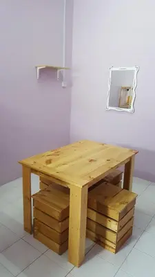 a wooden table with a mirror on a wall at Cottage Muslim Homestay ByWawaSha in Tanjung Malim