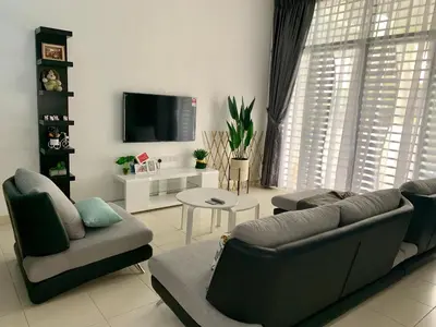 a living room with a couch and a tv at BRAND NEW Cosy Minimalist Home in Butterworth