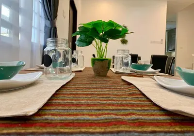 a table with glasses and a potted plant on it at BRAND NEW Cosy Minimalist Home in Butterworth