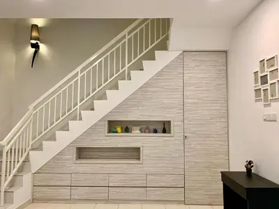 a staircase in a living room with a stone wall at BRAND NEW Cosy Minimalist Home in Butterworth