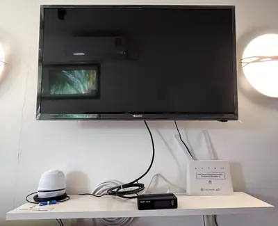 a flat screen tv hanging on a wall at Yellow Cube at Lumut Cube Homestay Kontena in Lumut