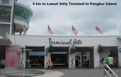 a building with american flags on top of it at Yellow Cube at Lumut Cube Homestay Kontena in Lumut