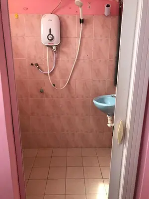 a bathroom with a shower and a sink at Hotel Cahaya in Tanjung Malim