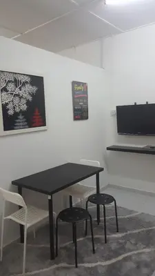 a black table and two chairs in a room at Homestay / Roomstay Muslim Budget Tanjung Malim in Tanjung Malim