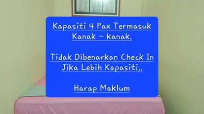 a blue sign sitting on top of a bed at Homestay / Roomstay Muslim Budget Tanjung Malim in Tanjung Malim