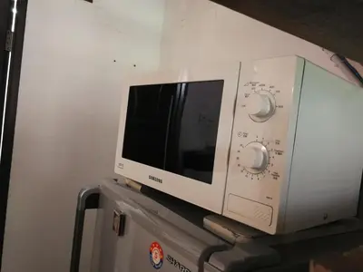 a microwave oven sitting on top of a cabinet at Great Shanghai Guesthouse in George Town