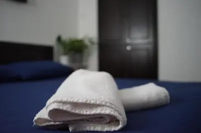 a pile of towels sitting on top of a bed at Great Shanghai Guesthouse in George Town