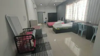 a hospital room with two beds and a table and chairs at Baoyousongsong in Kampar