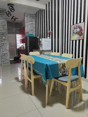 a dining room table with chairs and a blue table cloth at Teratak Delisha -musslim in Kampong Jemampar