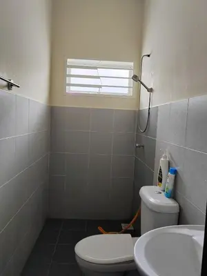 a bathroom with a toilet and a sink and a window at Teratak Delisha -musslim in Kampong Jemampar