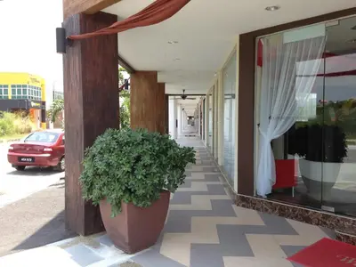 a plant in a pot sitting outside of a building at Hotel Checkedinn in Ipoh