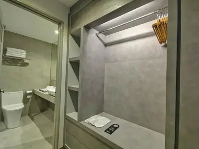a bathroom with a shower with a toilet and a sink at Frame Hotel in George Town
