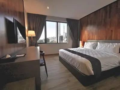 a hotel room with a bed and a desk at Frame Hotel in George Town