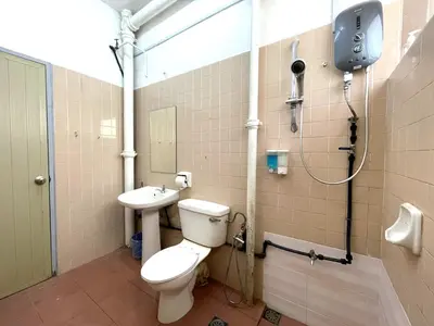 a bathroom with a toilet and a sink at Hotel O Wg Guest House in George Town