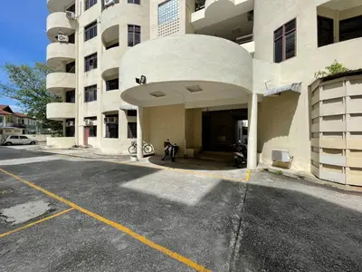 an empty parking lot in front of a building at Hotel O Wg Guest House in George Town