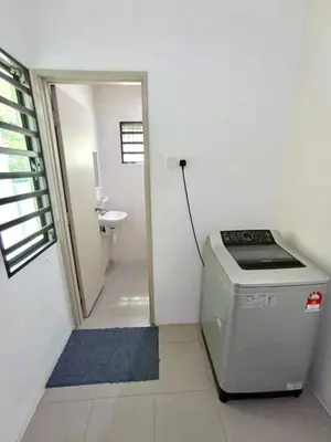 a small bathroom with a sink and a washing machine at TROPICAL LIVINGS MERU IPOH HOMESTAY by Grab A Stay in Ipoh
