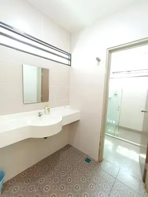a bathroom with two sinks and a mirror and a shower at TROPICAL LIVINGS MERU IPOH HOMESTAY by Grab A Stay in Ipoh