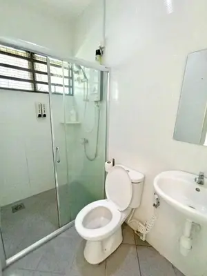 a bathroom with a toilet and a shower and a sink at TROPICAL LIVINGS MERU IPOH HOMESTAY by Grab A Stay in Ipoh