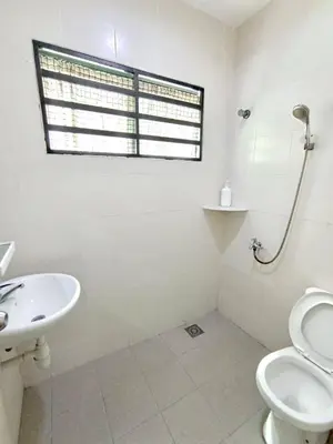 a bathroom with a sink and a toilet and a window at TROPICAL LIVINGS MERU IPOH HOMESTAY by Grab A Stay in Ipoh