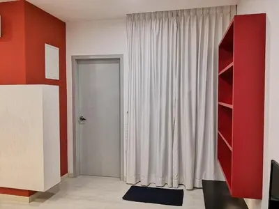 a room with a door and a red wall at Strait Garden Suites X Ace Pro @ George Town in Jelutong