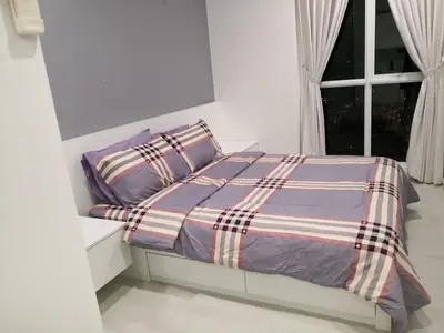 a bed in a white room with a window at Strait Garden Suites X Ace Pro @ George Town in Jelutong