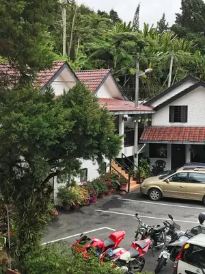 a group of motorcycles parked in a parking lot at Cameronian Inn in Cameron Highlands