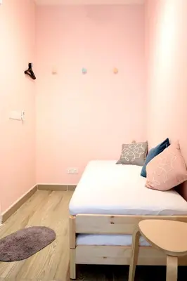a bedroom with a bed and a table at Octagon Ipoh by Plush in Ipoh