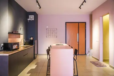 a kitchen with a white refrigerator in a room at Octagon Ipoh by Plush in Ipoh